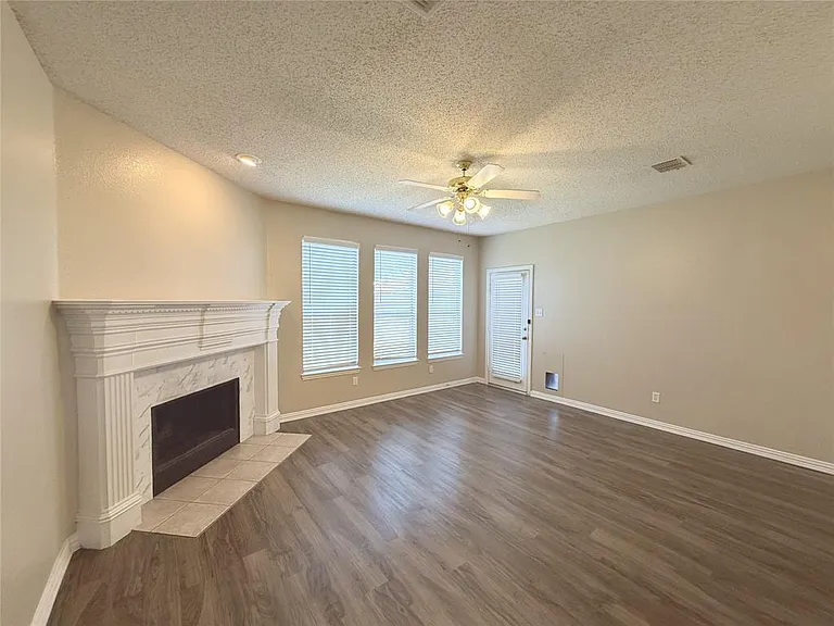LARGE OPEN DEN TO KITCHEN WITH WOOD BURNING FIREPLACE. LVP FLOORING AND FRESH PAINT.