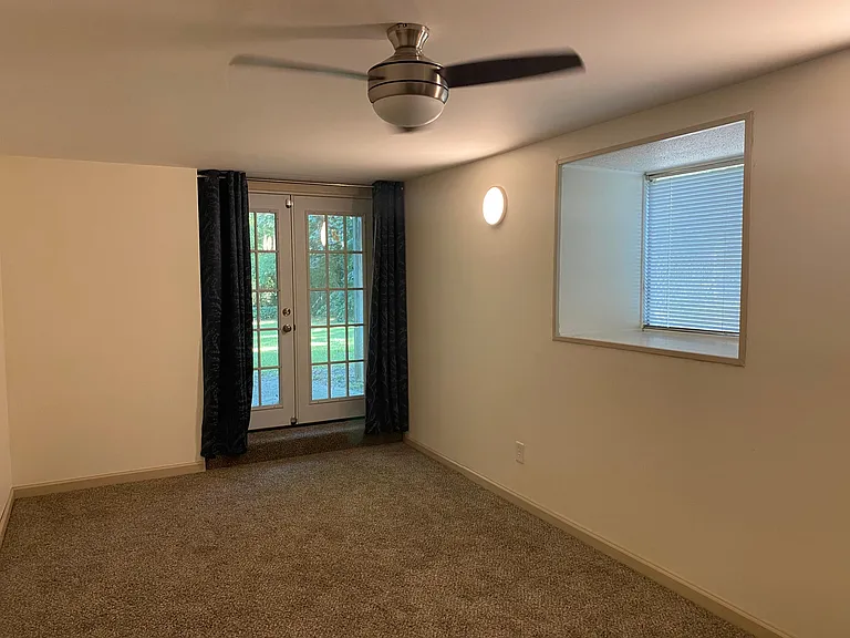 Basement level room opens to large, fenced backyard