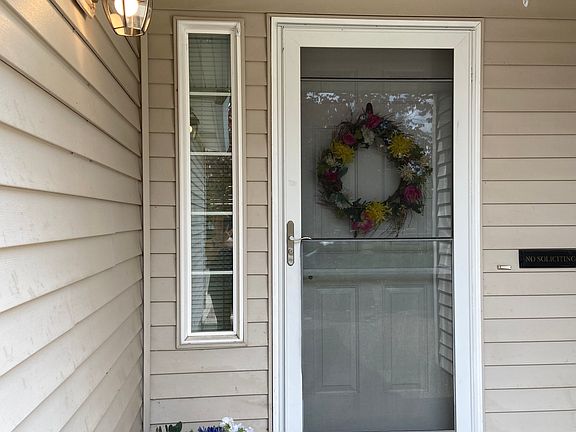Front door has new handle on storm door, new light fixture,doorbell.