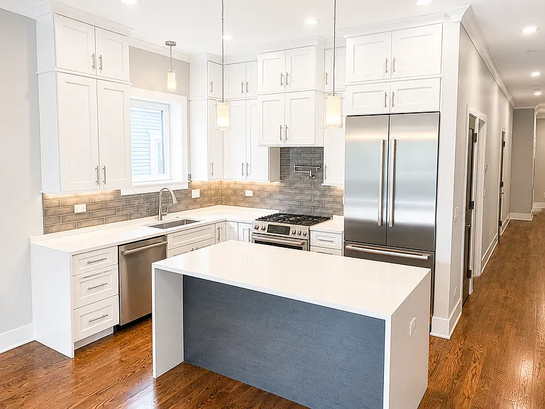 Bosch kitchen with quartz countertops, pot filler and under cabinet lighting
