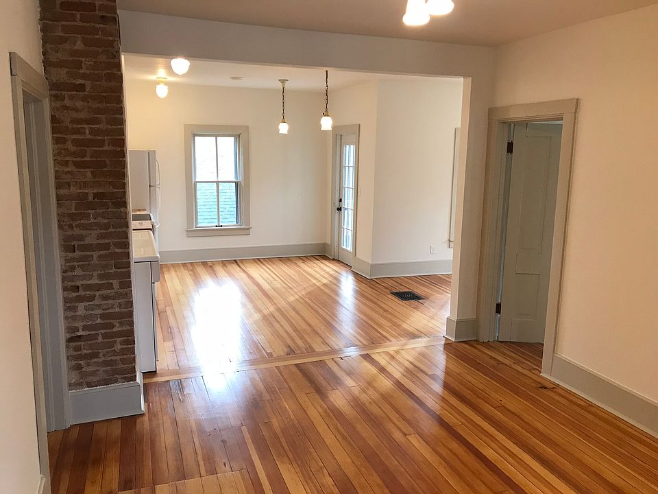 View from living room into kitchen with dining area to the right