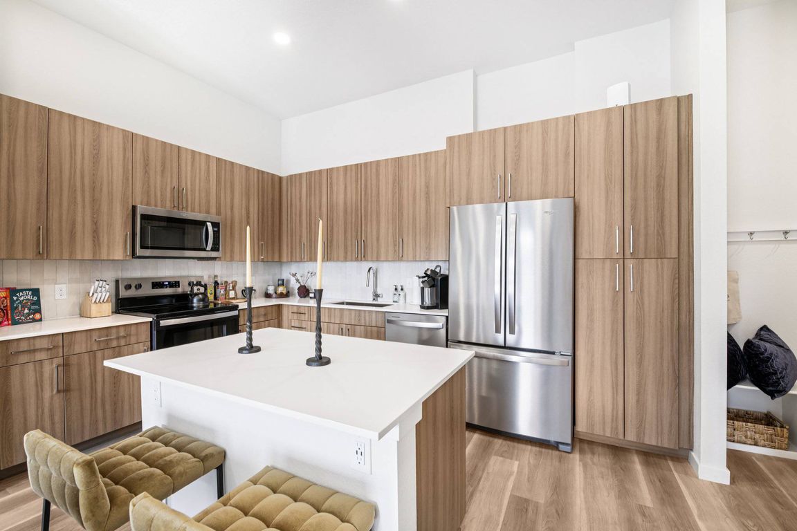 Quartz countertops with designer tile backsplashes at The Madison & The Fillmore