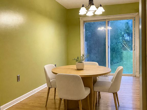 Open dining area with access to the rear patio. Staged.