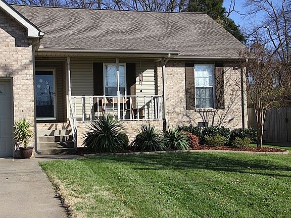 Lush landscaping and covered front porch 