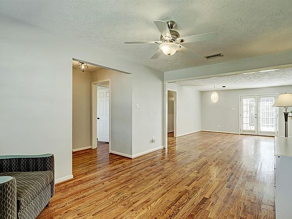 Living room open to the dining and patio doors.
