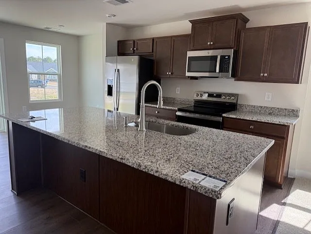 OPEN KITCHEN WITH LOTS OF CABINET, COUNTER SPACE, EAT AT BAR