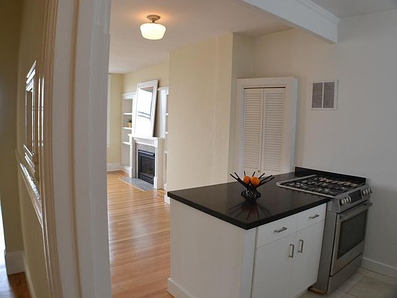 Open kitchen peninsula, dining area, and living room