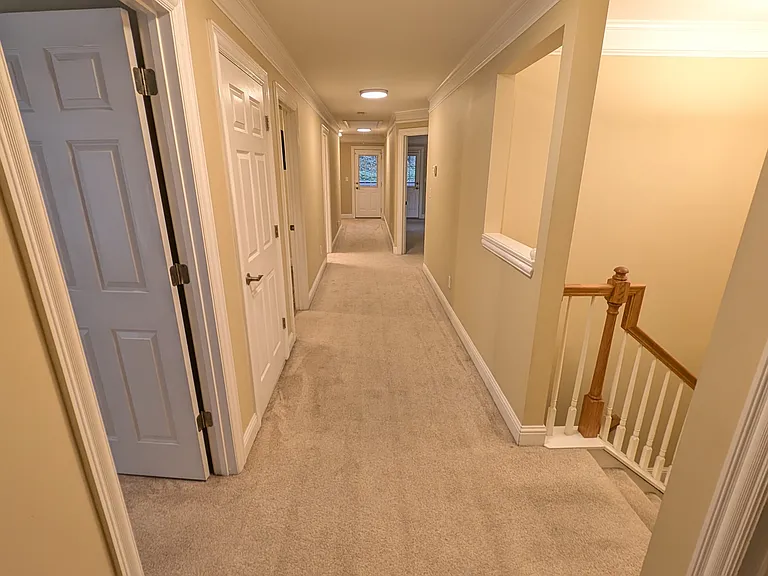 Second floor hallway. Entry point for all four bedrooms, laundry closet, and back deck access.
