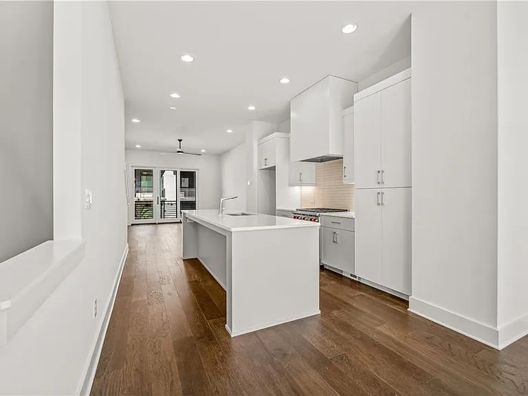 Kitchen (Note: Actual unit has light wooden floors and upgraded fixtures / appliances)