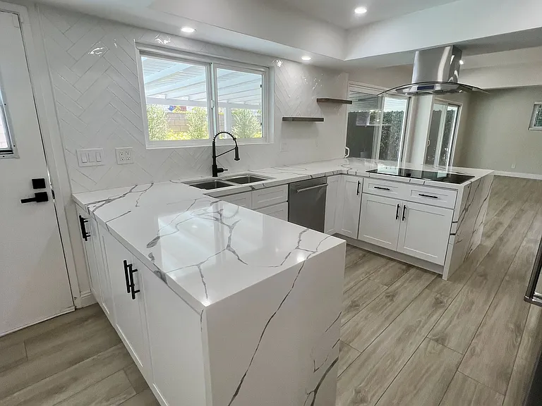 Remodeled kitchen with large granite countertop space