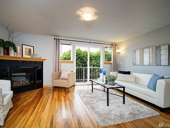 The living room features gorgeous, freshly refinished real oak flooring as well as gas fireplace with easy on/off switch on the wall, and large balcony with privacy that lets in a ton of natural light!