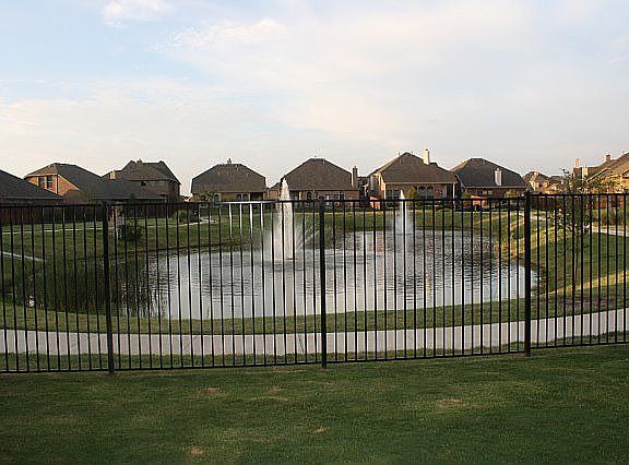 view from backyard of pond and fountains