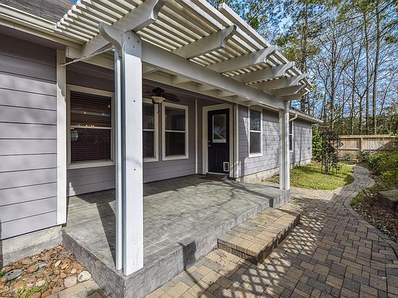 This outdoor living space is versatile for dining or reading. Notice no back neighbors to disturb your serenity.