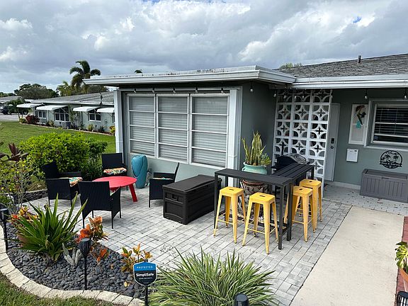 Relax on beautiful outside patio with sitting area, Bar, and BBQ surrounded by tropical perennials