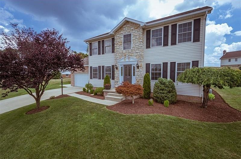 Welcome to 105 Cottonwood Drive. Stunning curb appeal. Beautifully landscaped. Immaculate.