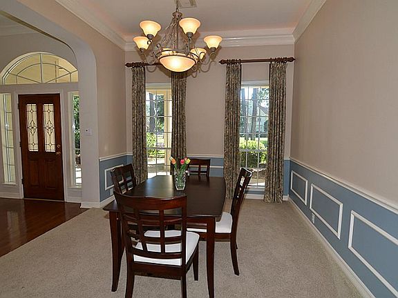Large formal dining room with custom window treatments, hight ceilings, extensive crown and picture moldings. This room can be your formal dining room or used as an office.