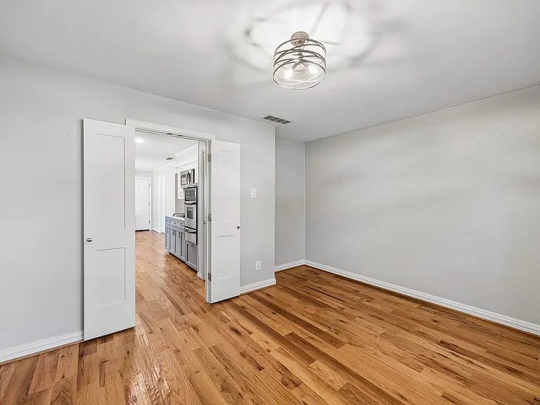Room featuring hardwood flooring and a contemporary semi-flush mount light fixture