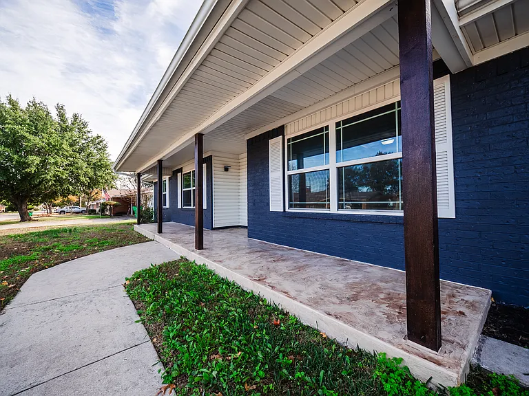 Front entrance with landscaped walkway and blue siding