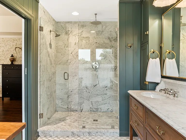Beautiful primary bathroom attached to bedroom #1. Enjoy a spacious double vanity, huge standing shower, and lots of natural light.
