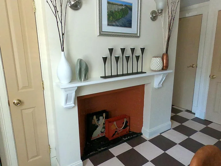 Decorative fireplace in eat in kitchen (shown prior to recent repainting).