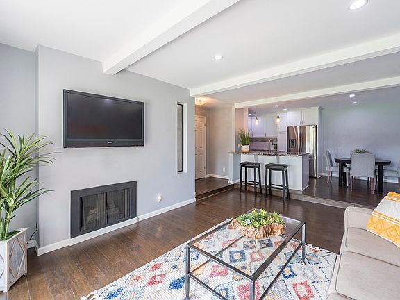 Large Living Room with Cozy Fireplace and open to the Kitchen/Dining Areas.