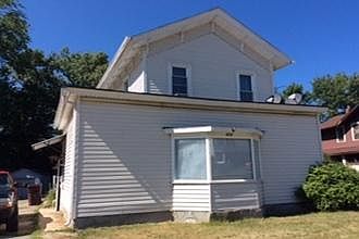 Outside of triplex, front, unit is upstairs