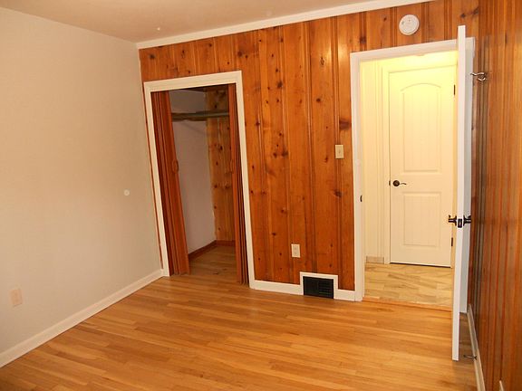 Bedroom with closet & hardwood floor.