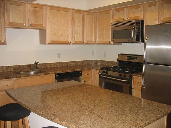 KITCHEN WITH GRANITE COUNTERTOPS AND STAINLESS STEEL APPLIANCES