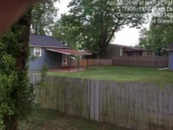 New black chain link fence in the backyard as of 2021. The photo is from 2019.