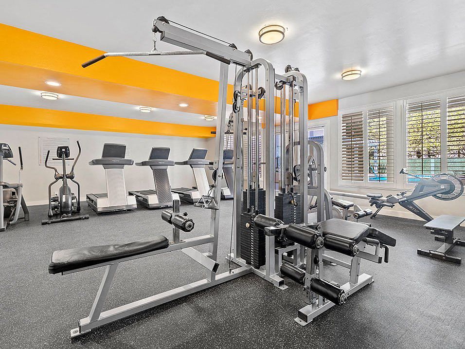 Community workout room with bikes, treadmills, and weight equipment