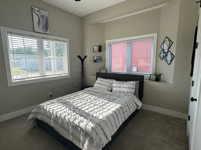 Guest bedroom queen bed shown with plenty of room, or home office