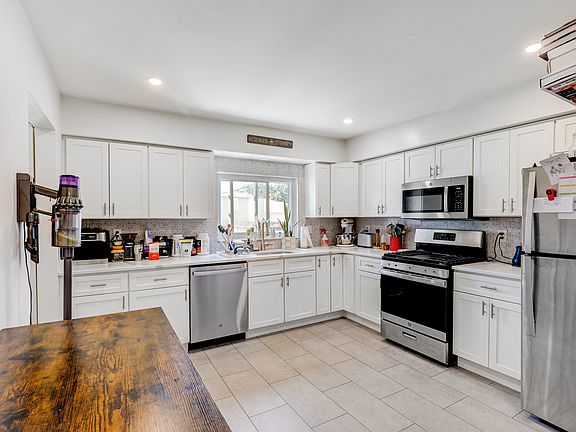 New large kitchen with quartz countertops and stainless steel appliances
