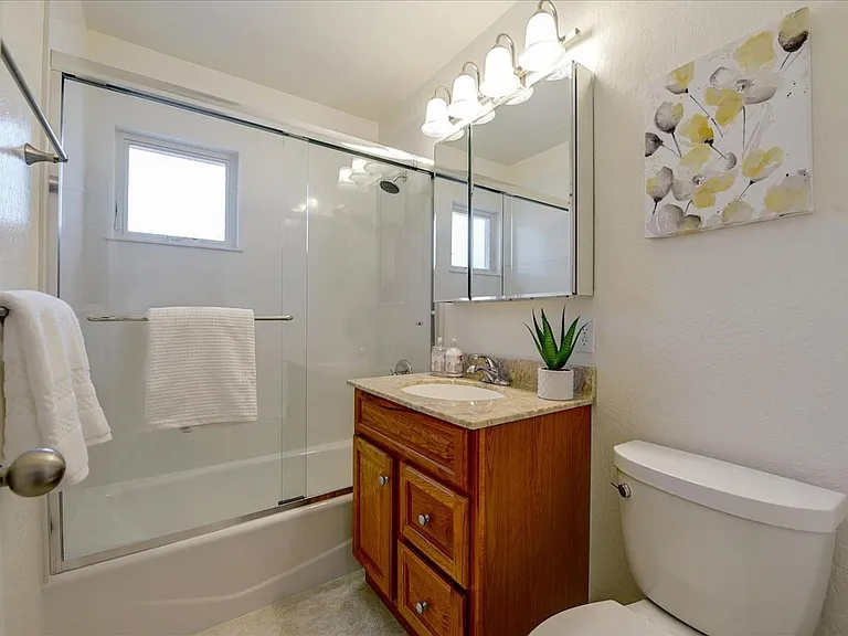 **Bathroom 2**
A bright full bathroom featuring a shower and bathtub combination, fresh towels, and ample storage_perfect for families and extended stays.