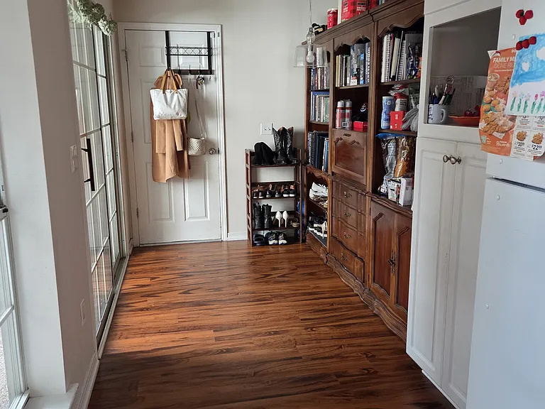 Kitchen facing garage door. Bookshelves will stay with property.