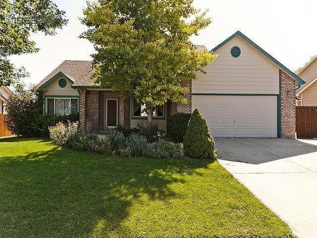 Front yard and 3-car driveway with paved side storage / drive