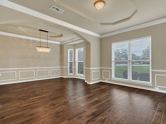 Formal living area with beautiful wood floors throughout the living areas and office on main floor.