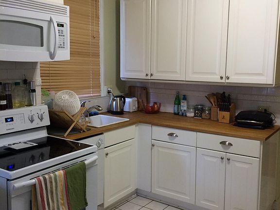 Spacious kitchen with plenty of storage. Countertops and tile floor have been recently replaced (not the ones shown in this photo. Want to see the new kitchen? Ask for pictures). Note the dishwasher to the left of the sink