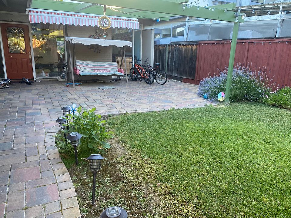 Entrance to the house with colorful flowers giving you a warm welcome. Retractable canopy in the frontyard for use when super sunny.
