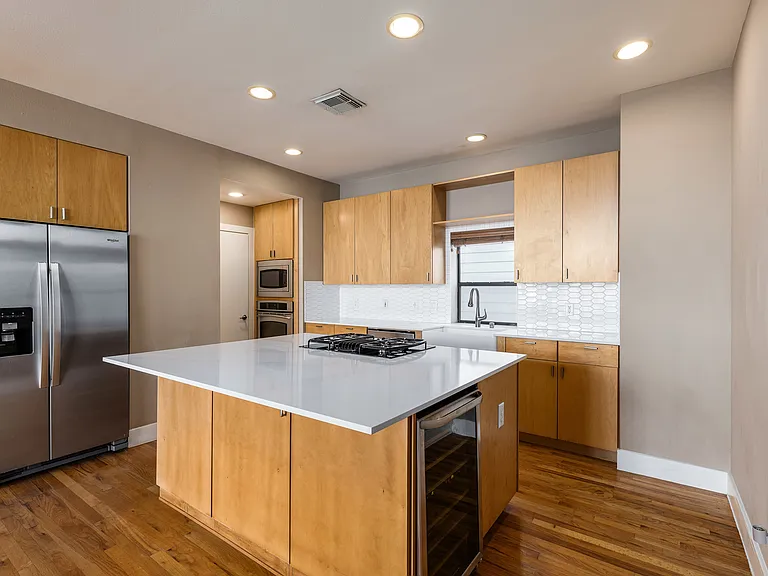 Remodeled kitchen with expanded island and wine fridge