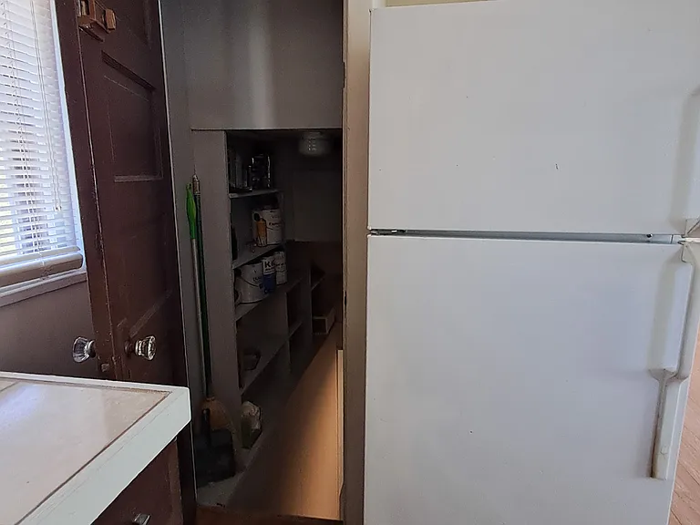 Part of kitchen showing basement door entry