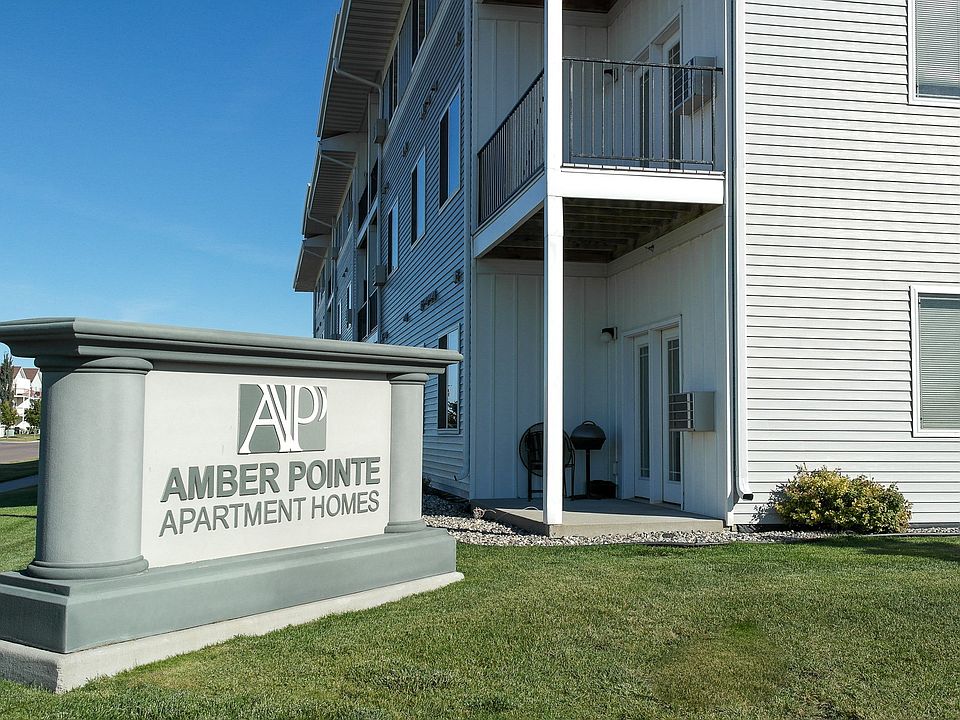 The exterior of Amber Pointe with an outside monument and views of the deck and patio.