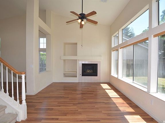 Separate family room with high ceiling, ceiling fan and fireplace