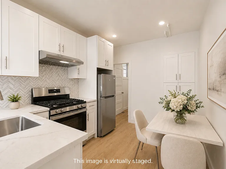 Newly updated bright and light full kitchen area with room for a small table. Pantry in the cabinets on the back wall
