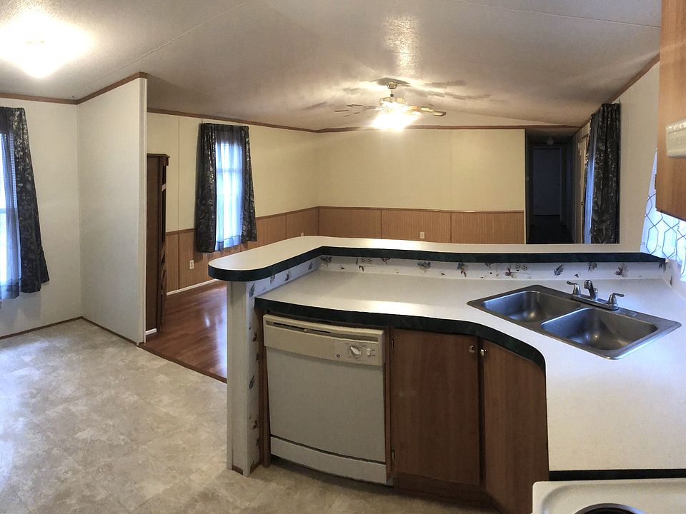 Standing in kitchen/dining, overlooking living room.