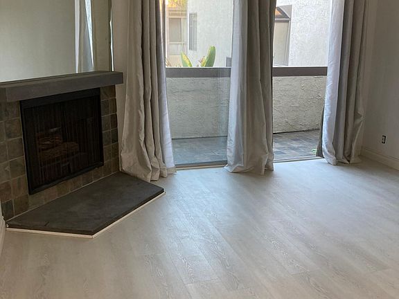 Living room, fireplace and balcony (different angle)