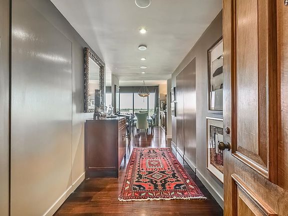 Gleaming hardwood floors throughout and abundant natural light greet you as you enter the home. Note the concealed doors that lead to an abundance of storage space.