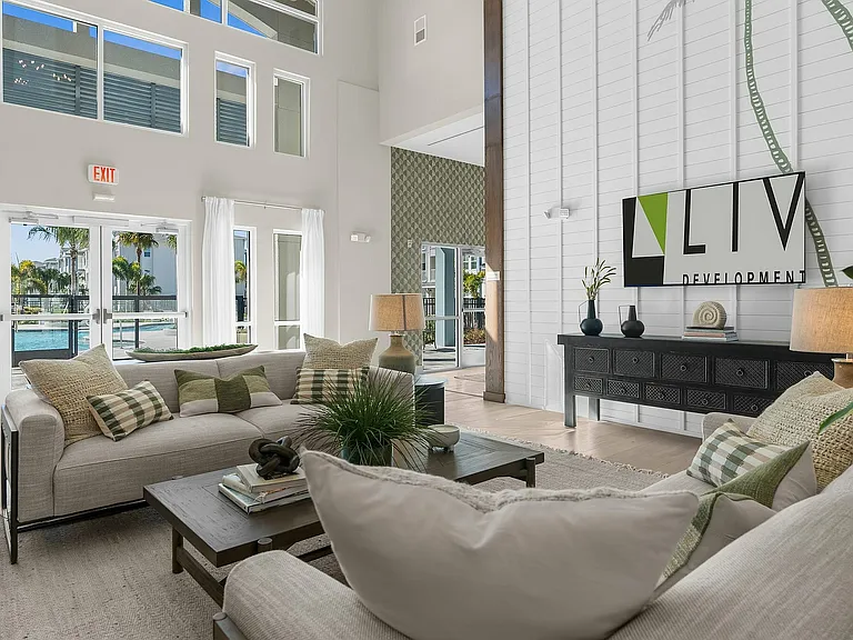 Experience relaxation in this stylish living room with a stunning poolside view.