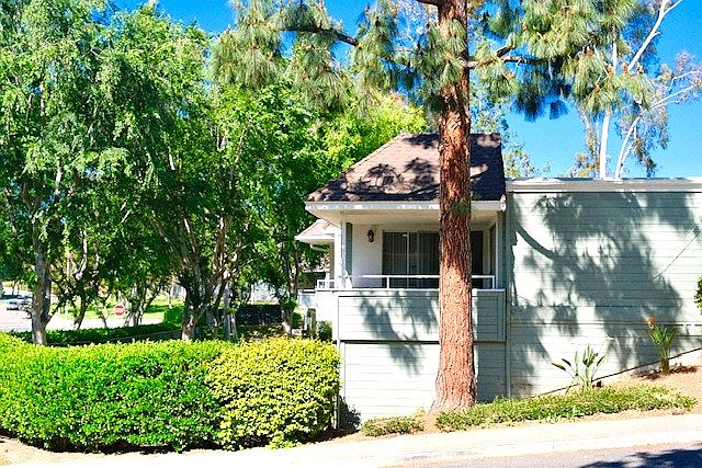 The corner condo unit is under the trees