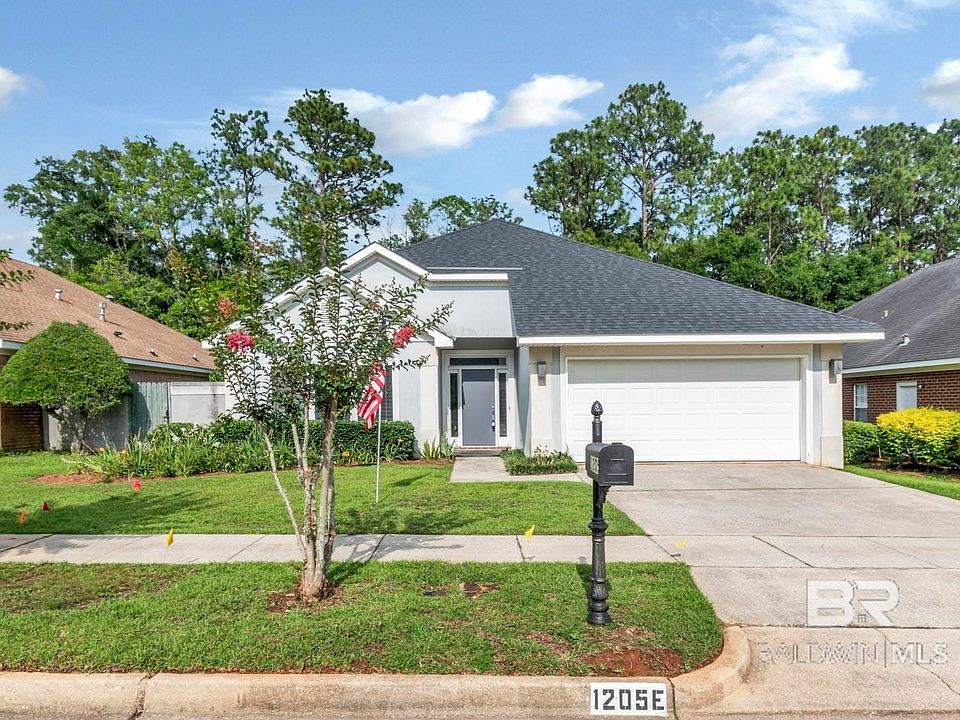 View of front of property with a garage and a front yard