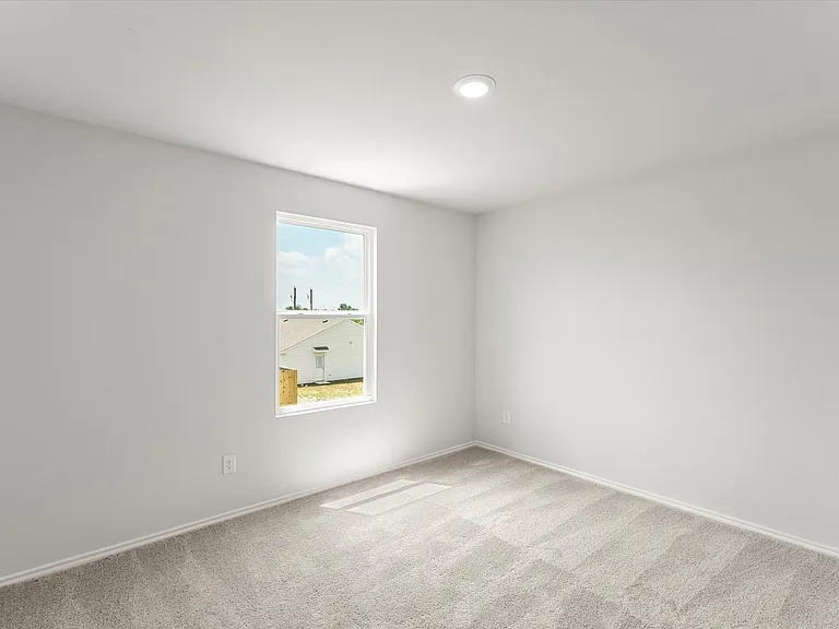 Room featuring light gray walls, plush gray carpet, a single window with white trim, and a recessed ceiling light